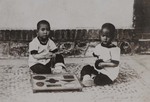 Orphans playing puzzle