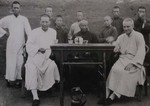 Chinese priests and Fr. Paul Gilson having tea in the garden
