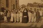 A Little Sister of St. Teresa with children