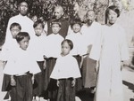Fr. Vincent Lebbe and Fr. Jean-Baptiste Fan with a group of dressed-up young girls