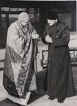 Fr. Raymond de Jaegher with a Lama dress belonging to Mgr. Joseph Comisso 2
