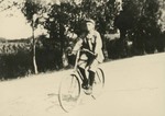 Frédéric (Vincent) Lebbe on a bicycle