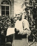 Fr. Lebbe holding a copy of a newspaper