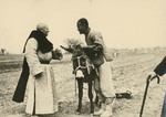 Fr. Vincent Lebbe chatting with a peasant ploughing his field