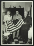 Sonora Dodd, Allen G. Leslie, and another person with flag